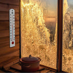 16" Vertical Outdoor Thermometer on wood-panelling next to an icy window